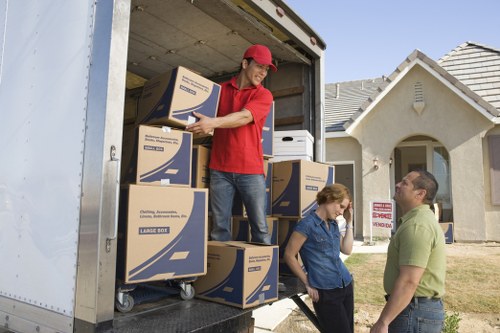 Moving service team handling sofas and household furniture