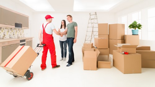 Local movers carrying furniture during a Ruislip relocation