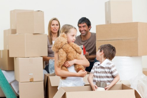 Family preparing boxes for a moving truck in Ruislip